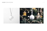 White bone china Christmas bauble mockup set showing one bauble on a plain background and another hanging on a tree.