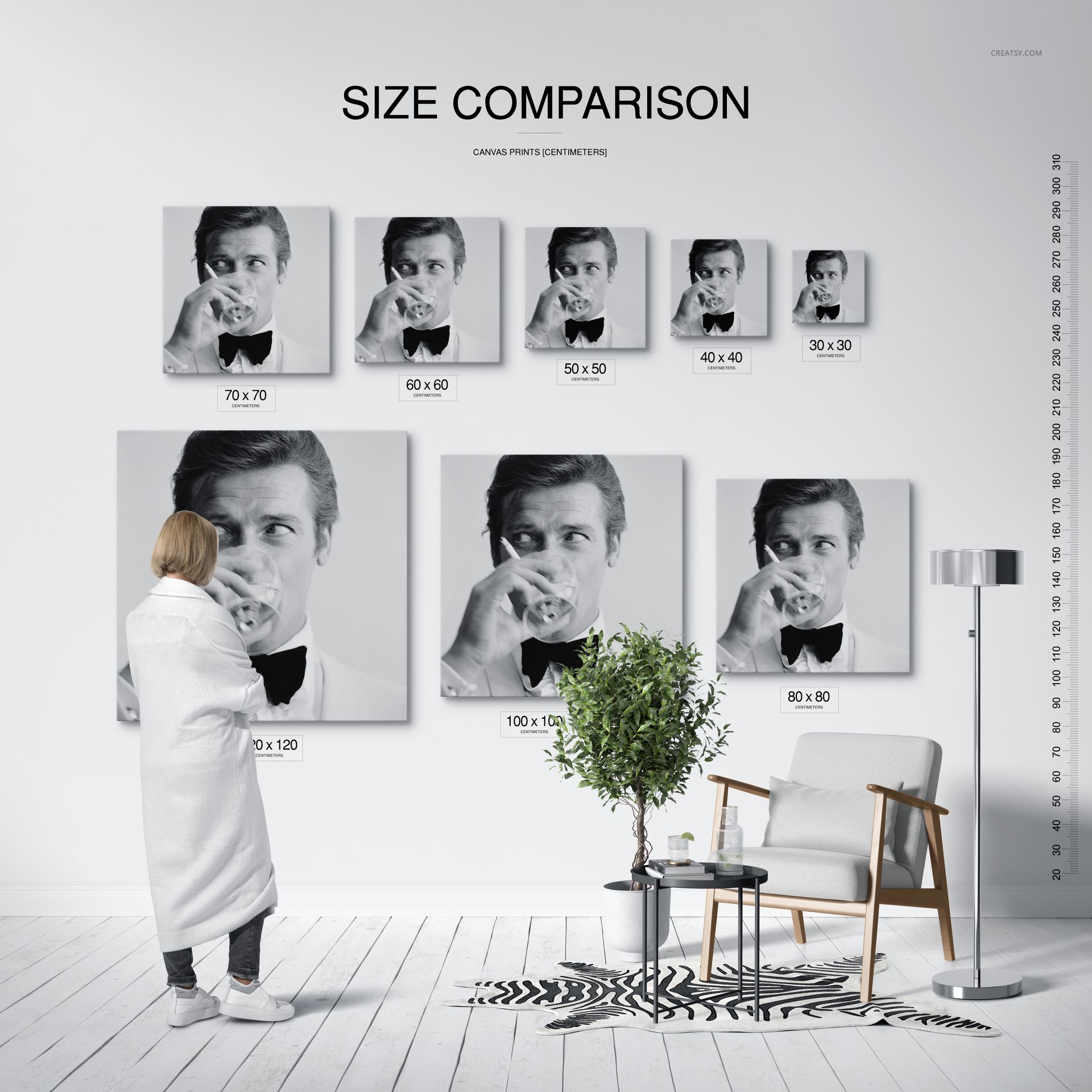 PSD mockup scene featuring canvas prints of varying dimensions, a person, ruler, chair, lamp, and plant in a bright interior.