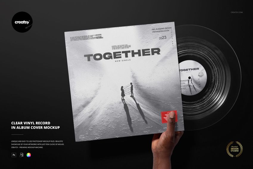 Mockup showing a clear vinyl record inside an album sleeve, with a hand holding the cover on a dark surface.