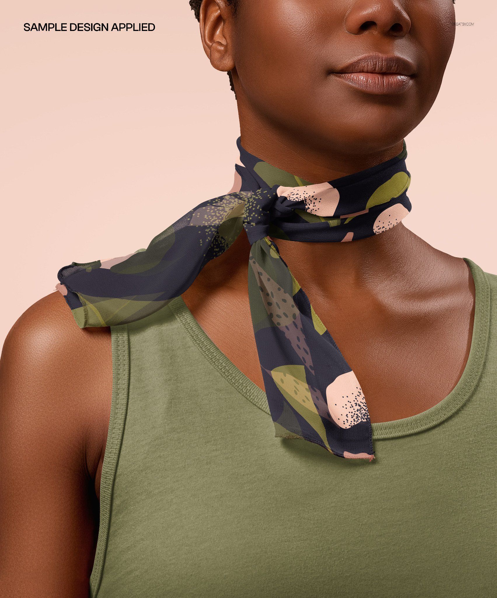 Close-up of a chiffon silk neck scarf mockup tied around a neck, featuring a dark abstract pattern.