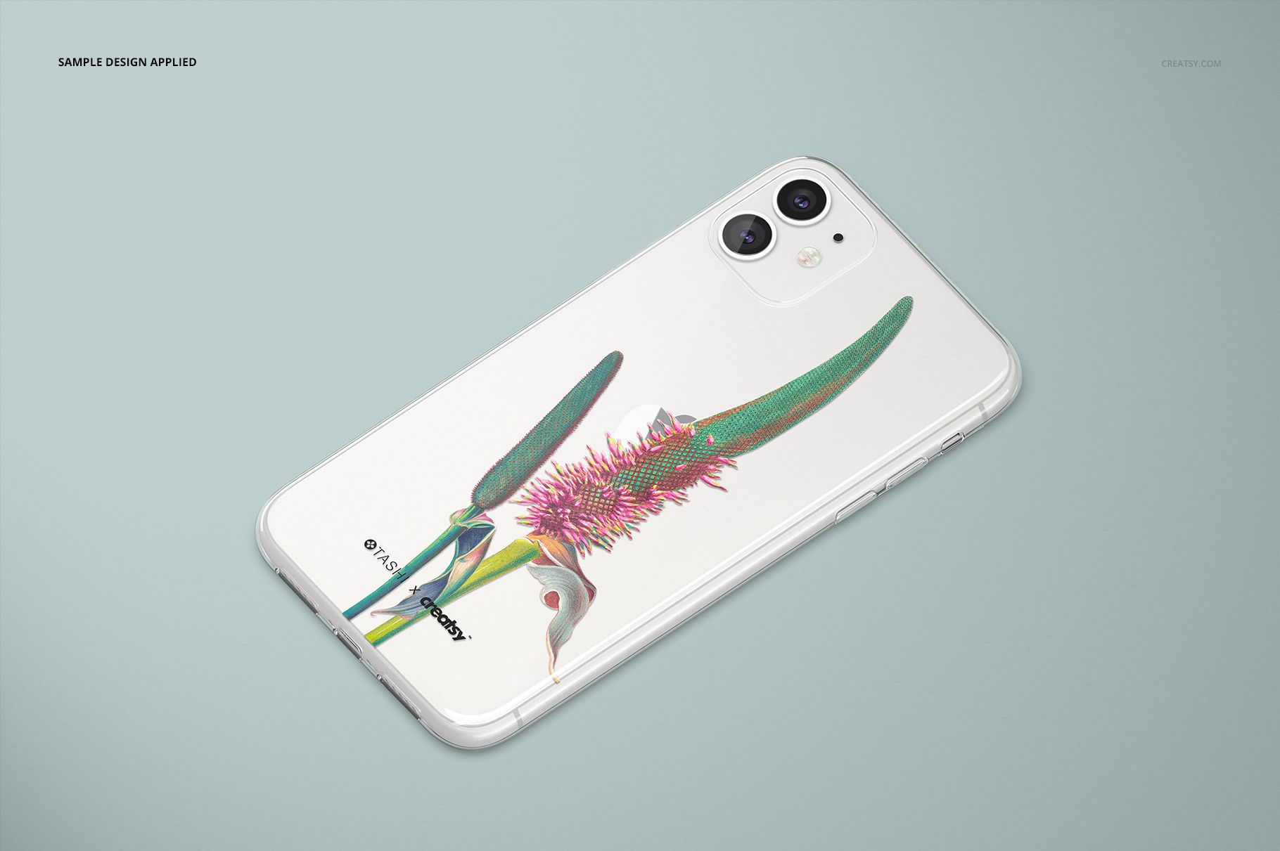 PSD mockup of an iPhone 11 with a clear case and vibrant flower artwork, placed on a soft gray surface.