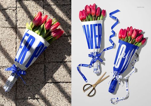 PSD mockup featuring tulip bouquets in white tissue wrapping with blue graphic text, arranged with ribbon and scissors nearby.