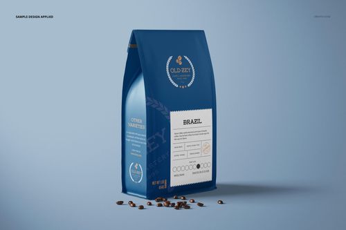 Blue paper coffee bag mockup displayed upright, featuring a white label and coffee beans on a neutral background.