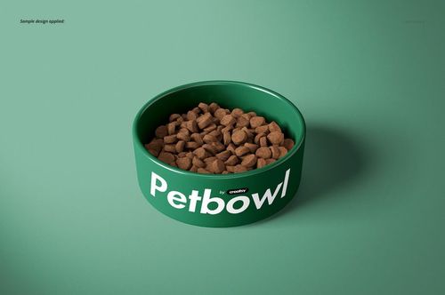 Round green pet bowl with white text, filled with dry pet food, displayed on a plain green surface, PSD mockup.