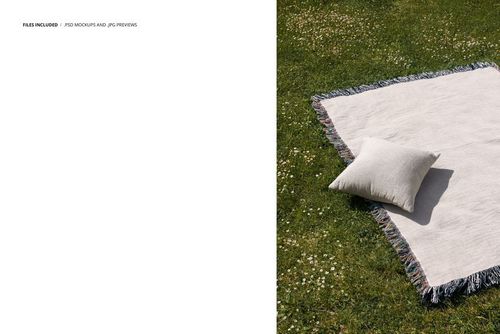 PSD mockup featuring a fringed blanket and pillow set on a sunlit outdoor meadow with small white flowers.