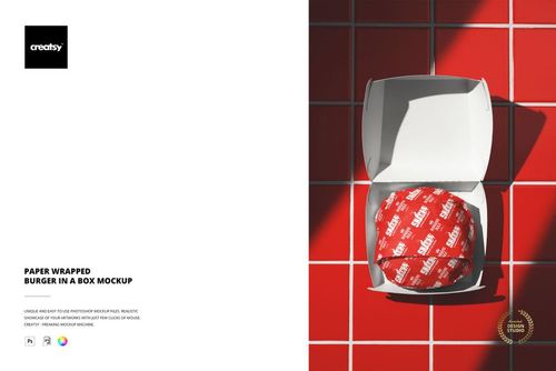 Paper wrapped burger in a white packaging box mockup, shown from above on a red tile background with sunlight.