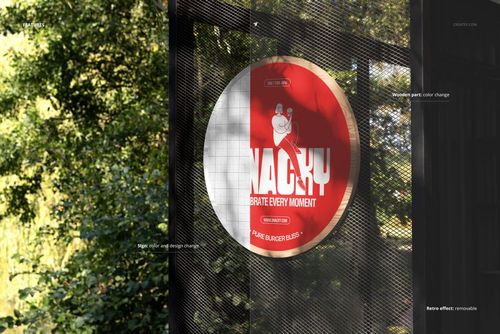 PSD mockup of a circular signboard featuring bold red and white colors, displayed on a black mesh structure outdoors.