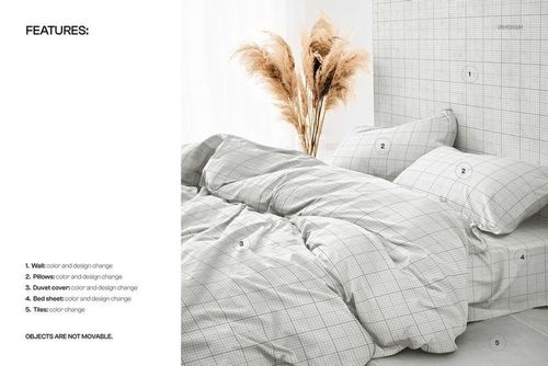 PSD mockup of a bed set with a grid-patterned duvet cover and pillowcases, styled with pampas grass in the background.