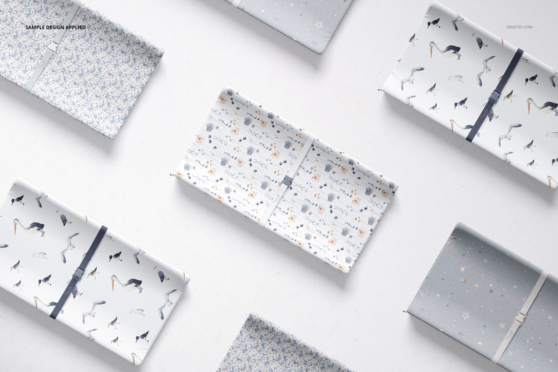 Flat lay of several changing pad mockups featuring different playful prints and neutral color schemes.