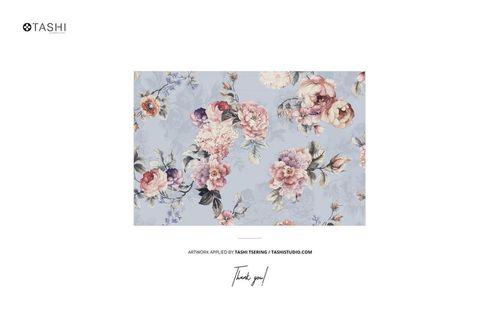 Rectangular cushion mockup with a floral pattern in pink, peach, and purple tones on a light blue background, front view.