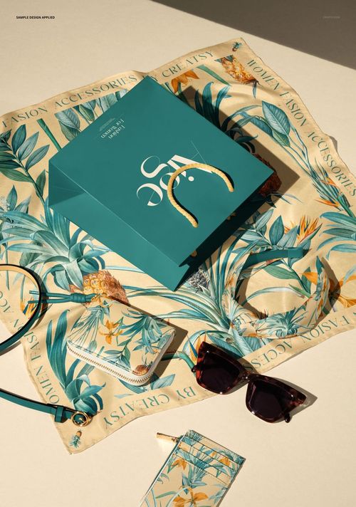 Fashion accessory PSD mockup featuring patterned silk scarf, shopping bag, wallet, belt, headband, and card holder.