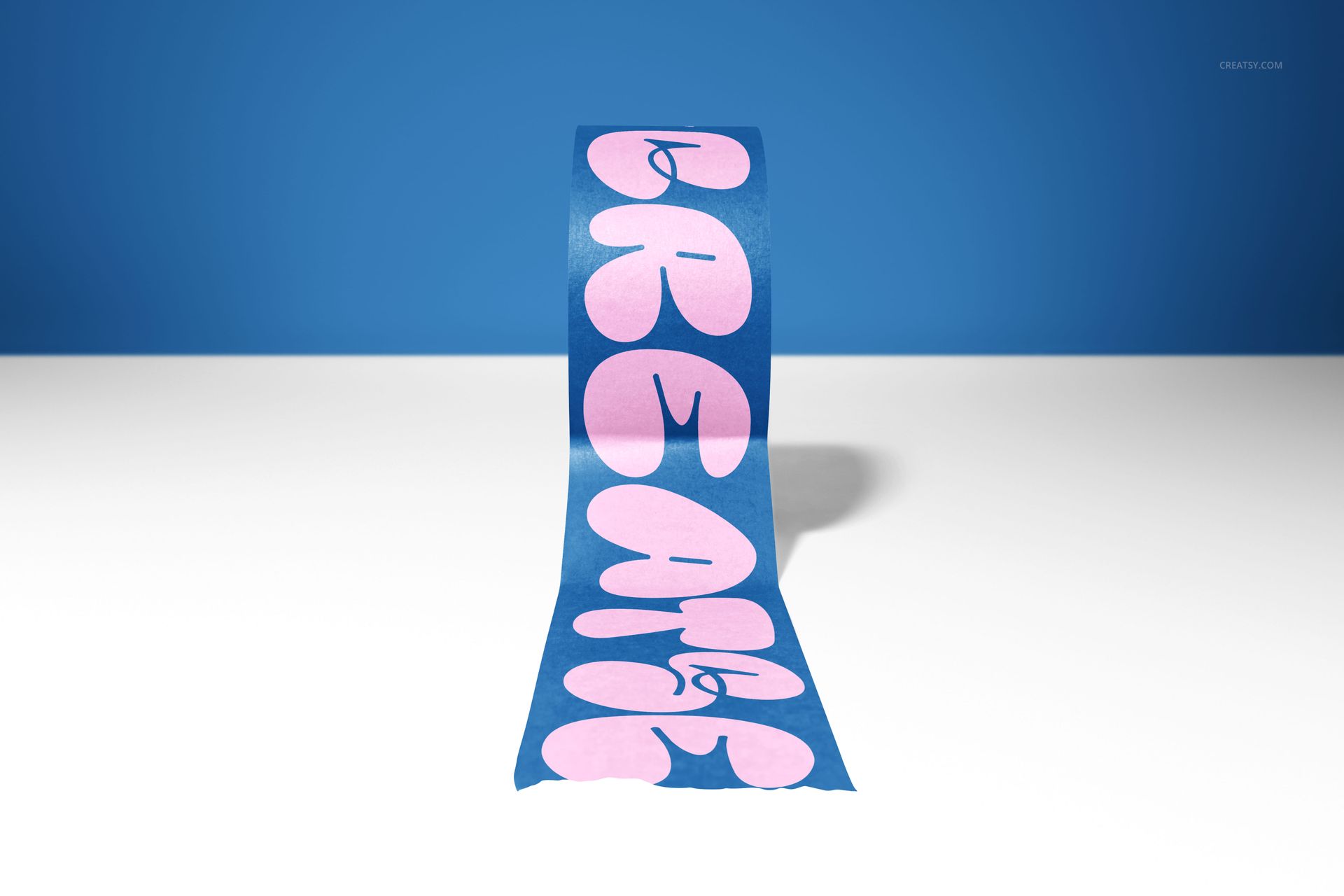 Front view of a packaging tape mockup featuring large pink letters on a blue tape, displayed on a white table.