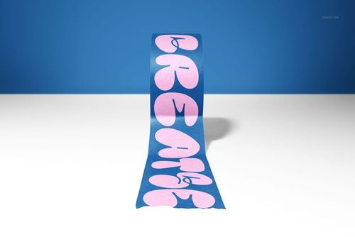 Front view of a packaging tape mockup featuring large pink letters on a blue tape, displayed on a white table.