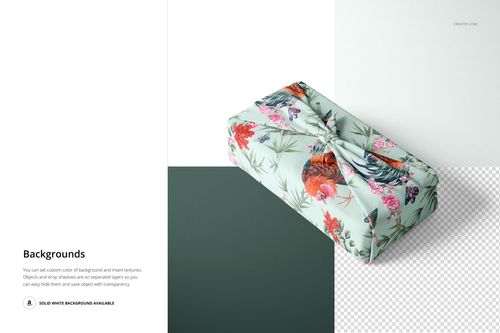 Furoshiki fabric wrap mockup featuring a light green textile with colorful flowers and birds, shown on two-tone backdrop.
