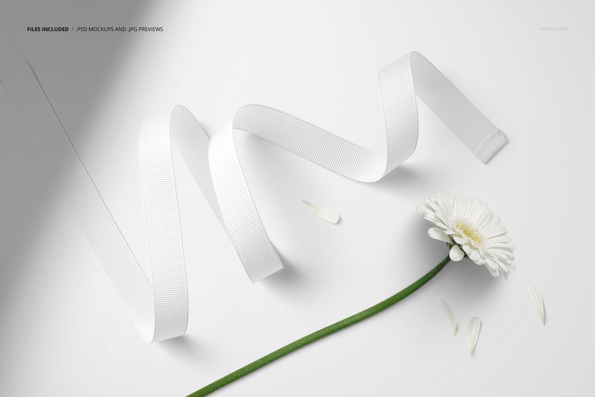 White grosgrain ribbon mockup displayed in a wavy arrangement beside a single white daisy on a light background.