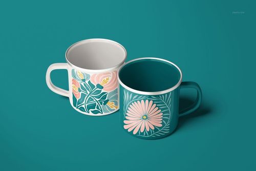 PSD mockup of enamel mugs with silver edges, each displaying a unique floral design in soft pink and green tones.