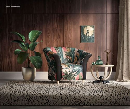 Front view of a tub armchair mockup featuring botanical patterned fabric, beside a round table and potted plant.