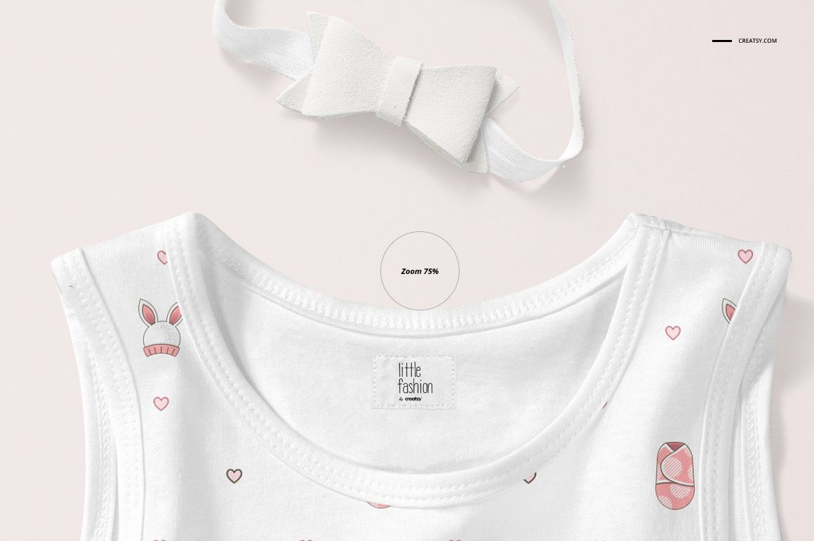 Close-up of a baby tank top mockup featuring a white fabric with subtle pink designs and a matching headband.
