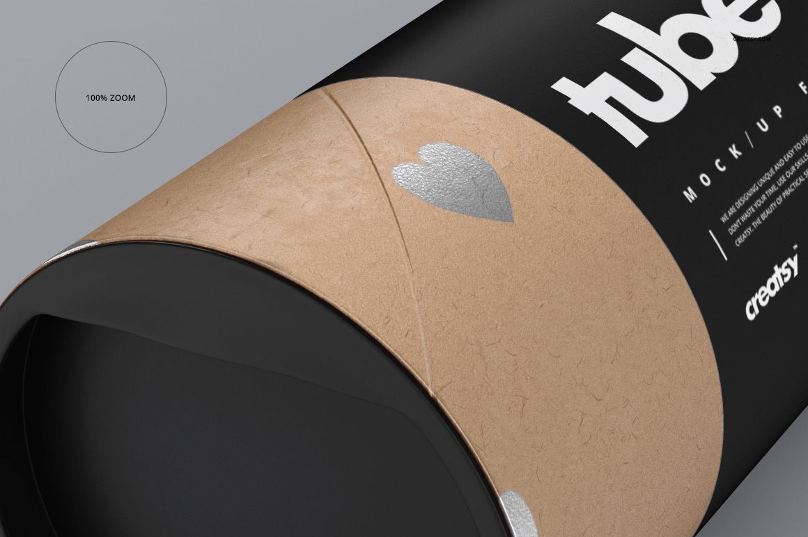 Close-up front view of a paper tube packaging mockup with a matte black lid and brown body featuring silver heart shapes.