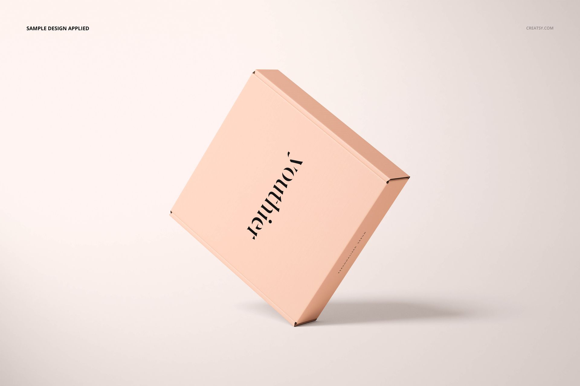 Peach-colored cosmetic box mockup displayed diagonally, featuring simple black lettering on a neutral backdrop.
