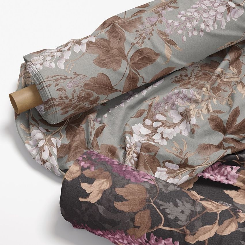 Fabric rolls mockup featuring two rolls of cloth with floral patterns in muted brown, lavender, and gray tones on a white background.