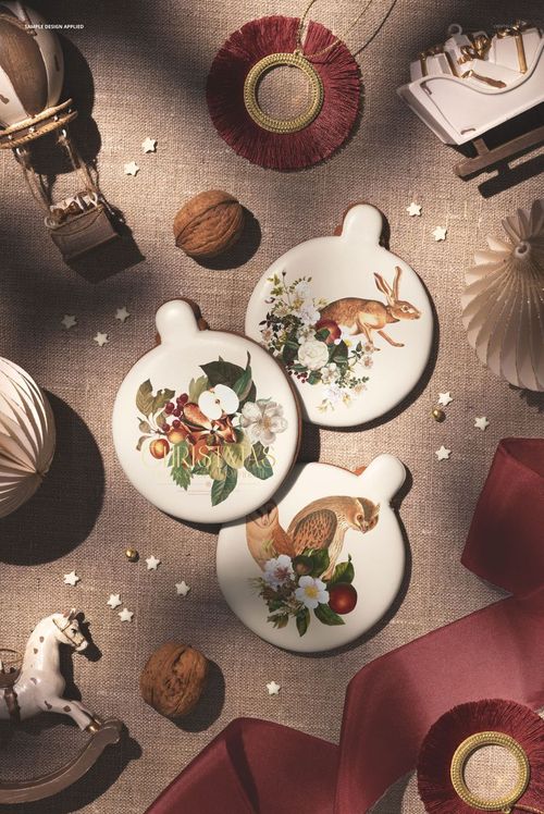 Festive PSD mockup showing gingerbread cookies with animal illustrations, walnuts, ribbon, and holiday decorations.