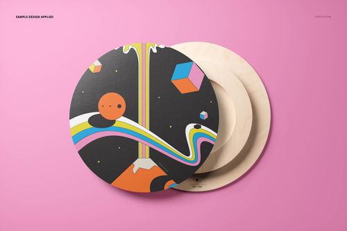 Round plywood wall art mockup featuring a colorful abstract design on a black background, displayed on a pink surface.