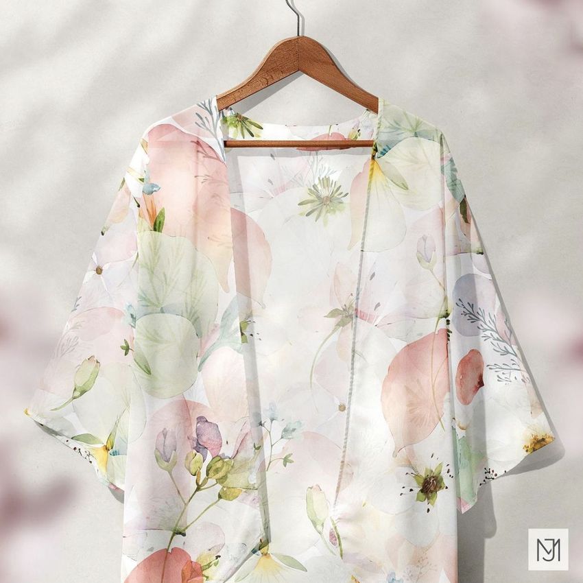 Chiffon kimono mockup featuring a soft pastel floral pattern, displayed on a wooden hanger against a light background.