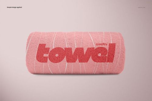 PSD mockup featuring a rolled pink towel with red text and white linear accents, positioned against a simple backdrop.