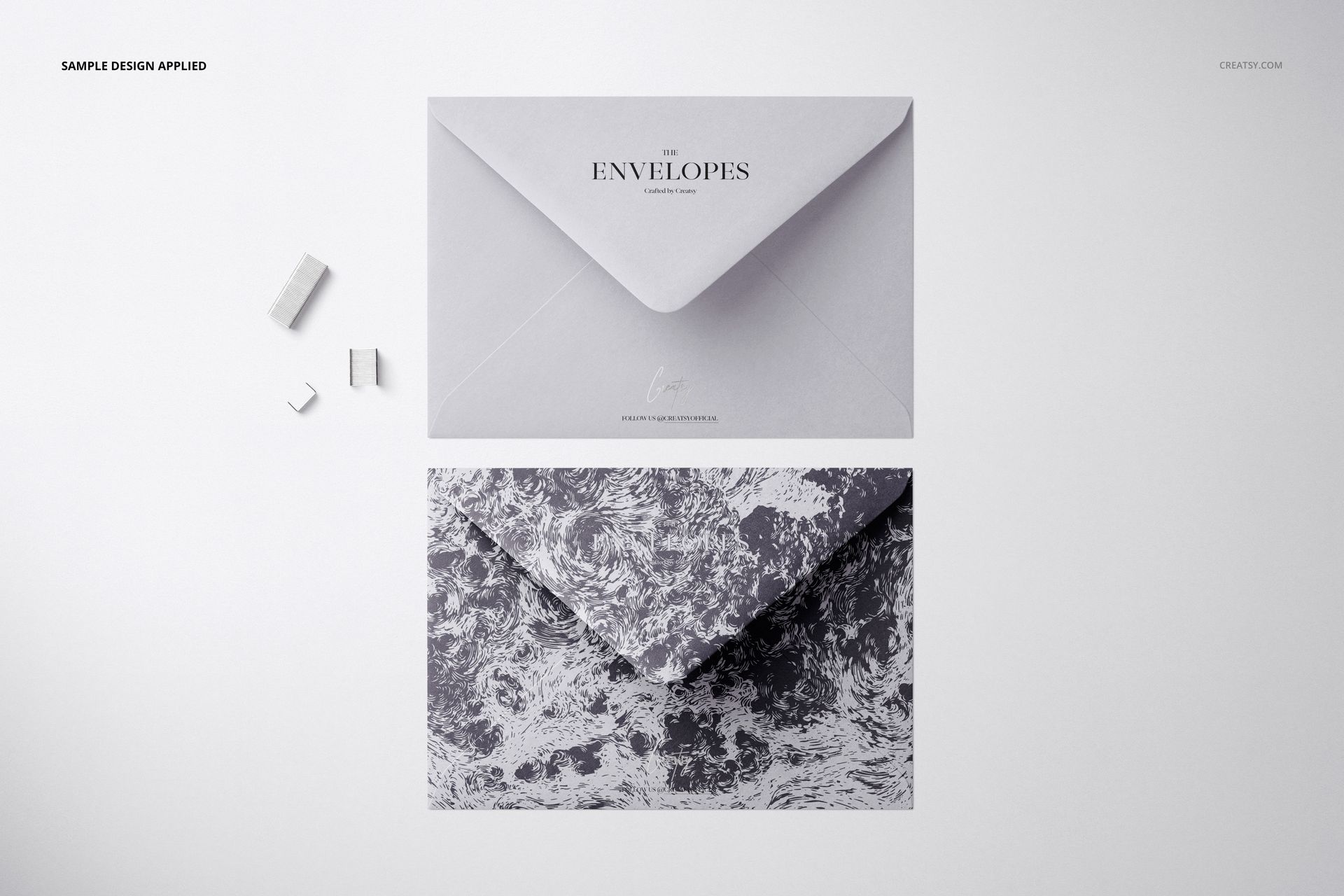 Stationery mockup showing two C6 envelopes, one with minimal text and one with an abstract monochrome design.