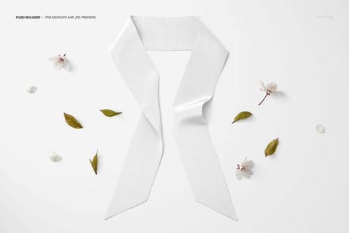 Top view of a white twilly scarf mockup arranged on a light surface with scattered leaves and white flowers.