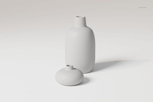 Two ceramic flower vases in matte white, one tall and cylindrical, one short and round, on a light surface.