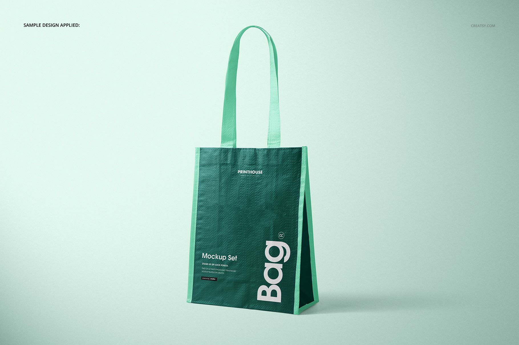 Green woven tote bag mockup displayed at an angle, showing textured fabric and printed white lettering on the front.