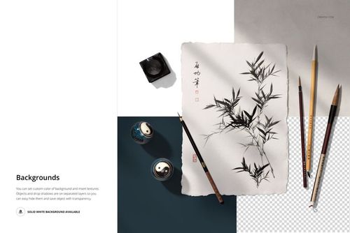 Japanese calligraphy mockup featuring a sheet of paper with bamboo ink art, surrounded by brushes and ink on a white surface.