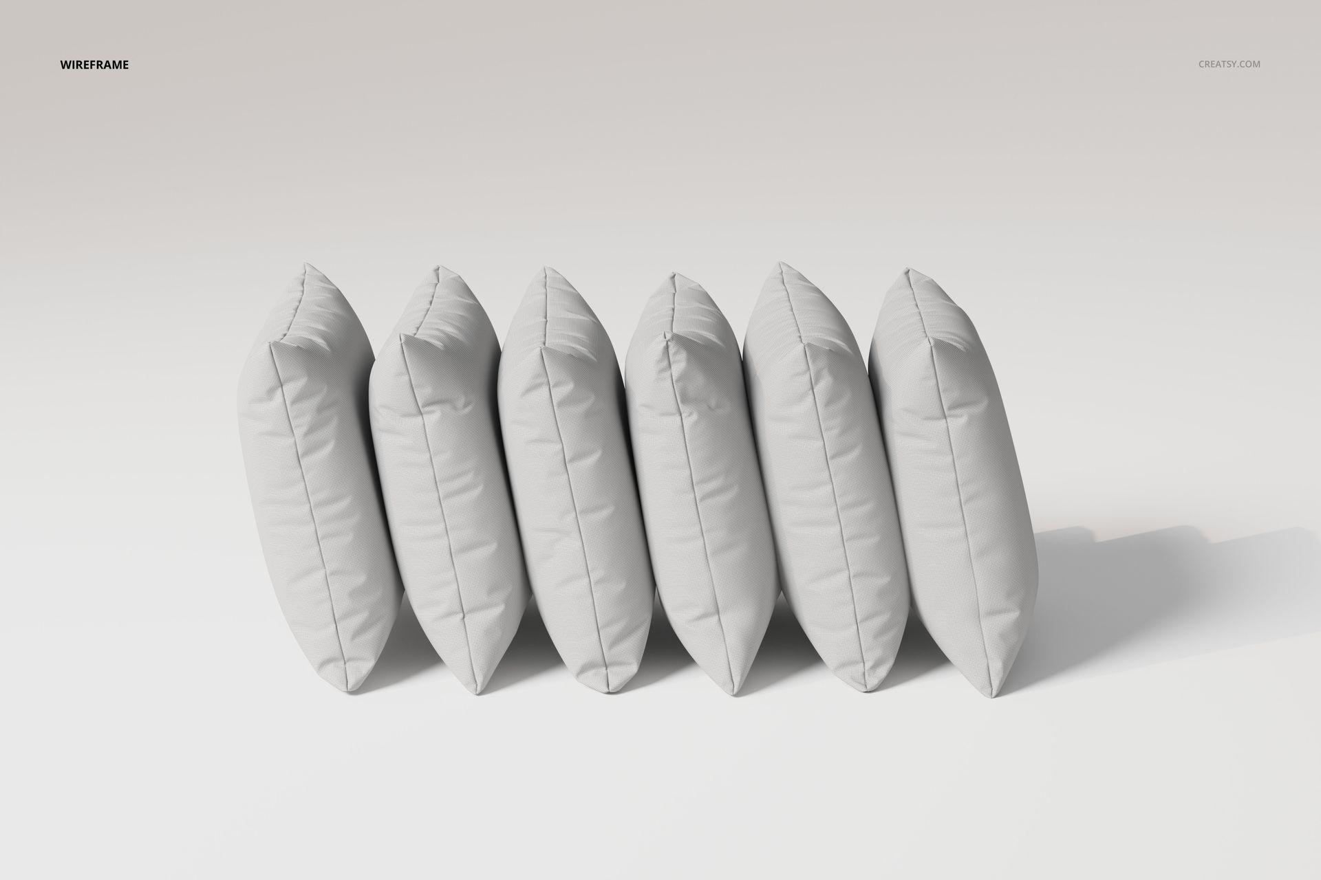 Six velvet cushions arranged in a row, viewed from the side, featuring a soft gray color on a plain background.