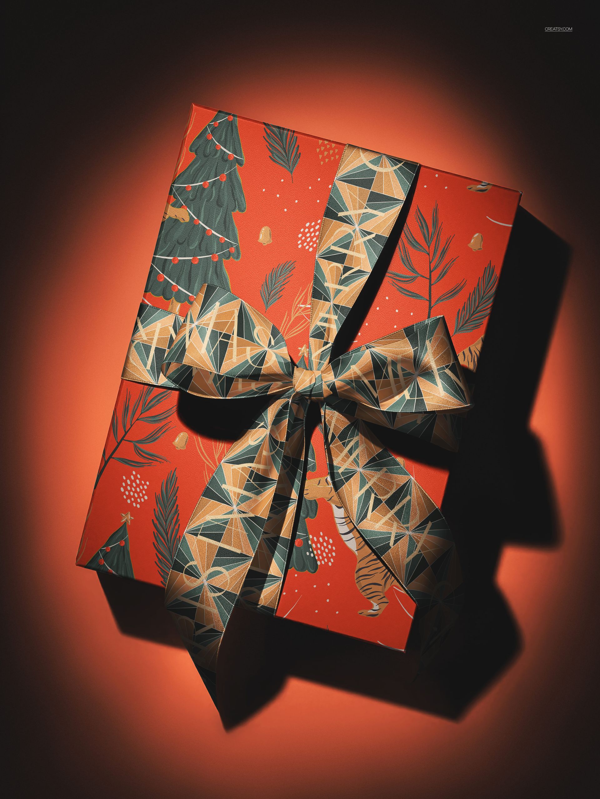 Christmas gift box mockup with red wrapping, festive tree and leaf patterns, and a large geometric ribbon, top view.