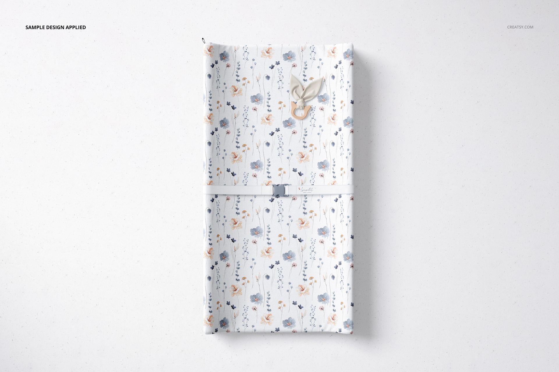 Rectangular changing pad mockup featuring a playful design with flowers and animals, viewed from above.