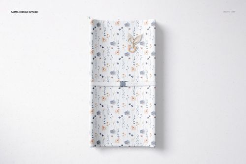 Rectangular changing pad mockup featuring a playful design with flowers and animals, viewed from above.