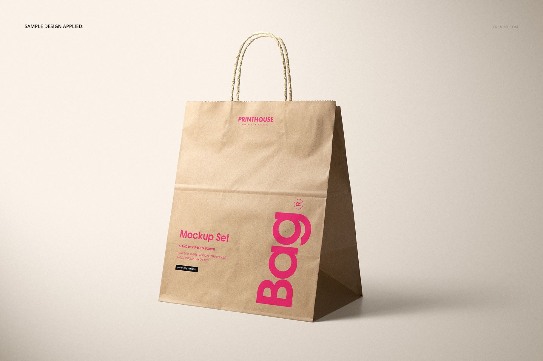 Brown kraft paper shopping bag mockup featuring rope handles and visible printed sample design, angled side view.