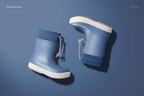 Two blue rain boots with white dotted pattern, shown from top view on a solid blue background, kids footwear mockup.
