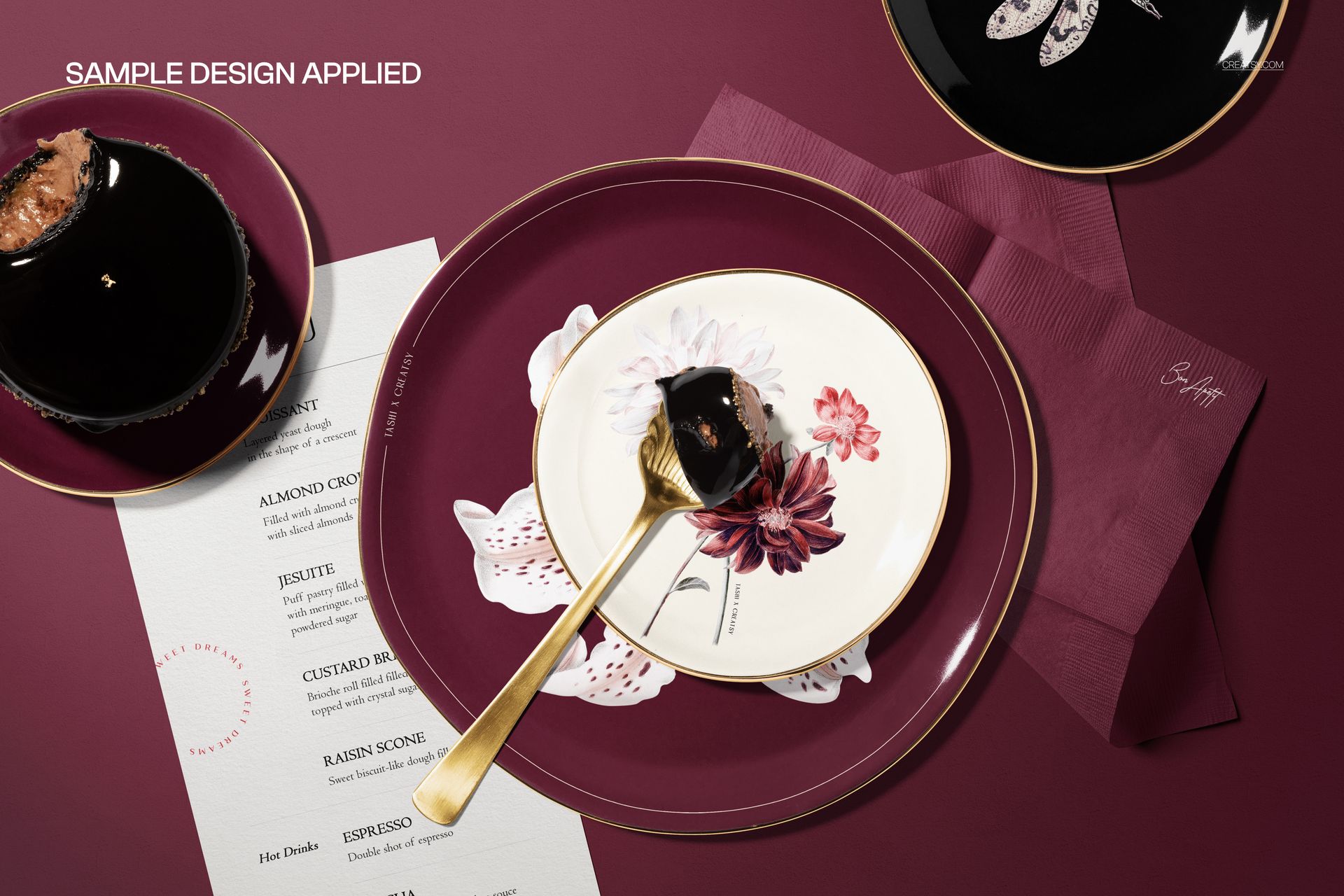 Dinnerware PSD mockup featuring a floral plate, dessert, burgundy napkin, and printed menu in a restaurant setting.