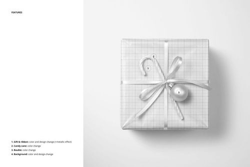 Christmas gift PSD mockup featuring a grid-patterned box, ribbon bow, candy cane, and decorative bauble in a minimal scene.