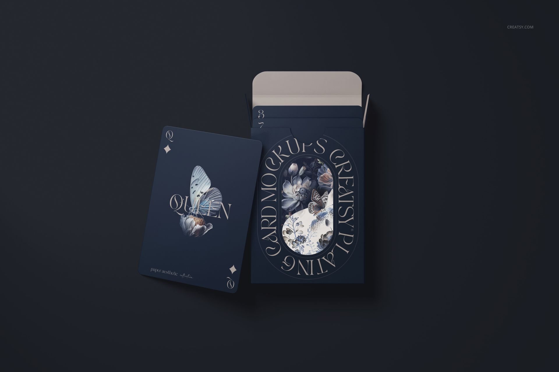 Top view of a playing card mockup with a butterfly illustration beside an open card box on a dark background.