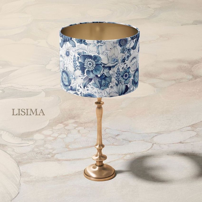 Drum lamp shade mockup featuring a gold lamp base and a blue floral patterned shade on a soft, neutral background.