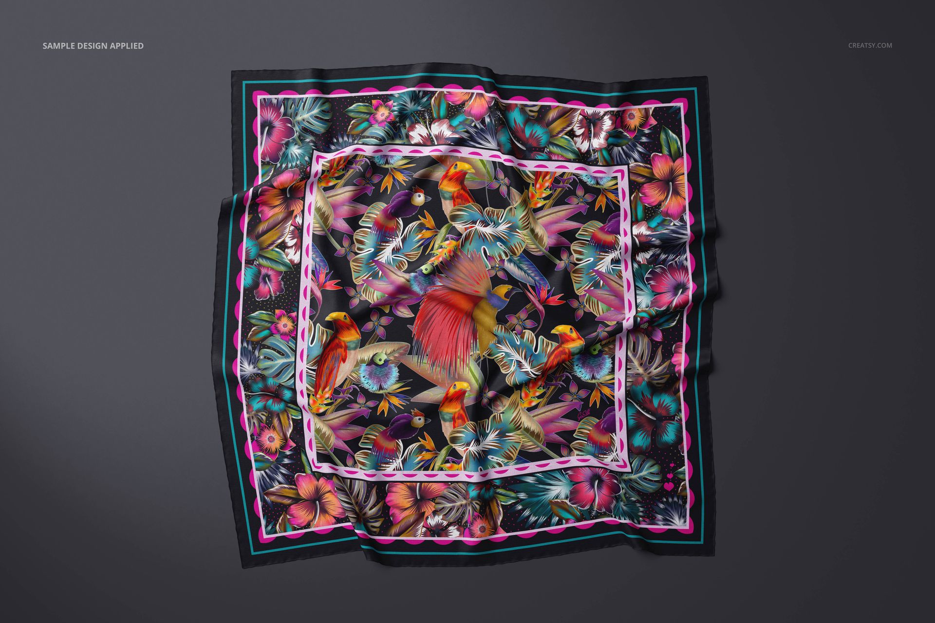 Square cashmere scarf mockup with vibrant tropical bird and floral pattern, displayed on a dark background, top view.