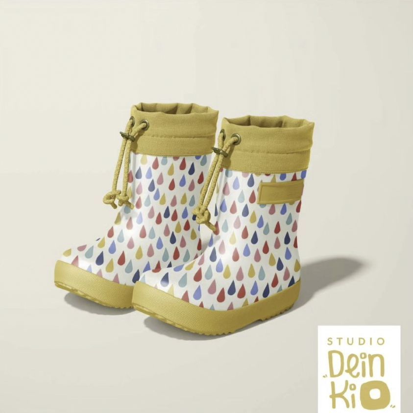 Kids rain boots mockup featuring a pair of boots with colorful raindrop patterns, yellow soles, and cuffs on a light background.