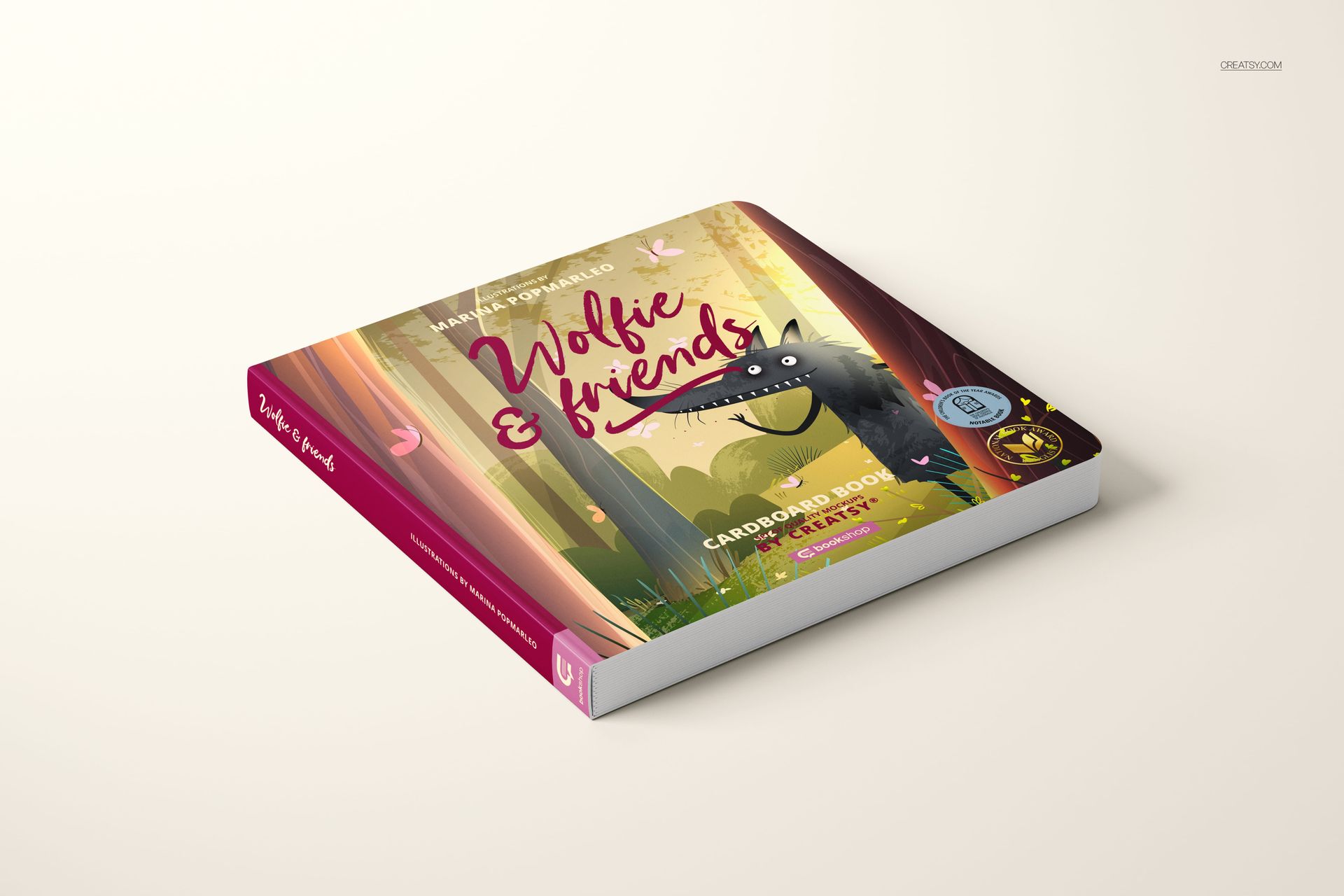 Square cardboard baby book mockup featuring colorful woodland artwork and wolf character, displayed at an angle.