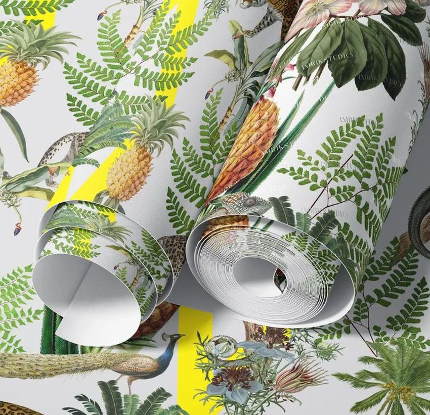 Paper wallpaper mockup featuring rolled sheets with a tropical pattern of pineapples, ferns, and exotic animals on a light background.