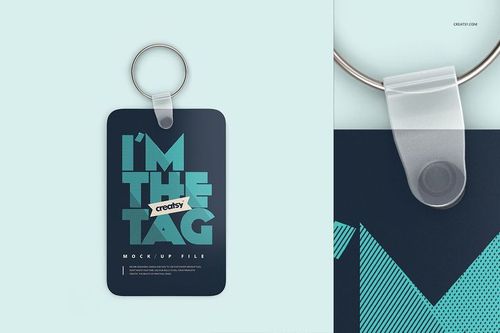 Keychain mockup featuring a dark rectangular tag with bold text, metal ring, and transparent connector on a pale blue surface.