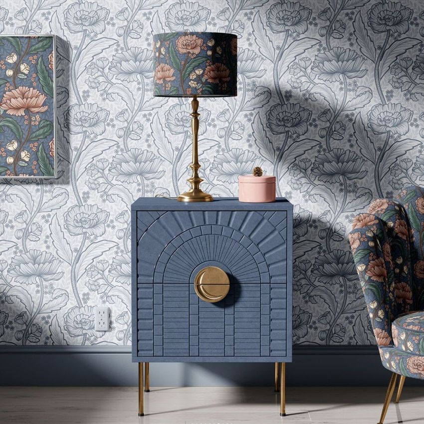 Drum lamp shade mockup featuring a floral pattern, displayed on a brass lamp atop a blue cabinet with matching decor.